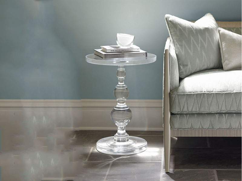 Transparent acrylic round table beside the sofa display